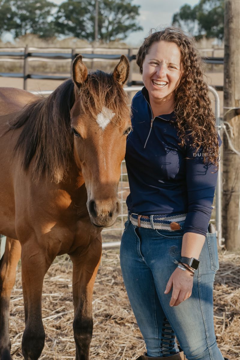 Dr Steph Fowler with a horse in a paddock